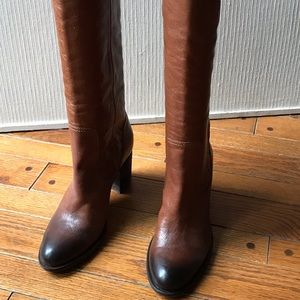 Knee high umbre brown leather boots.